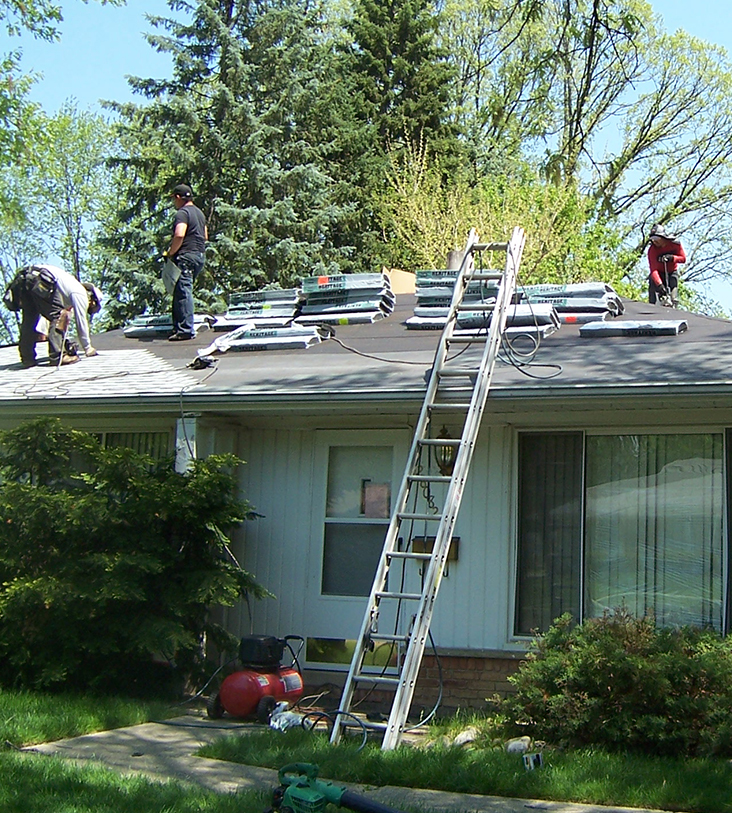 A Bobson Construction crew at work on a residential roof in Metro Detroit