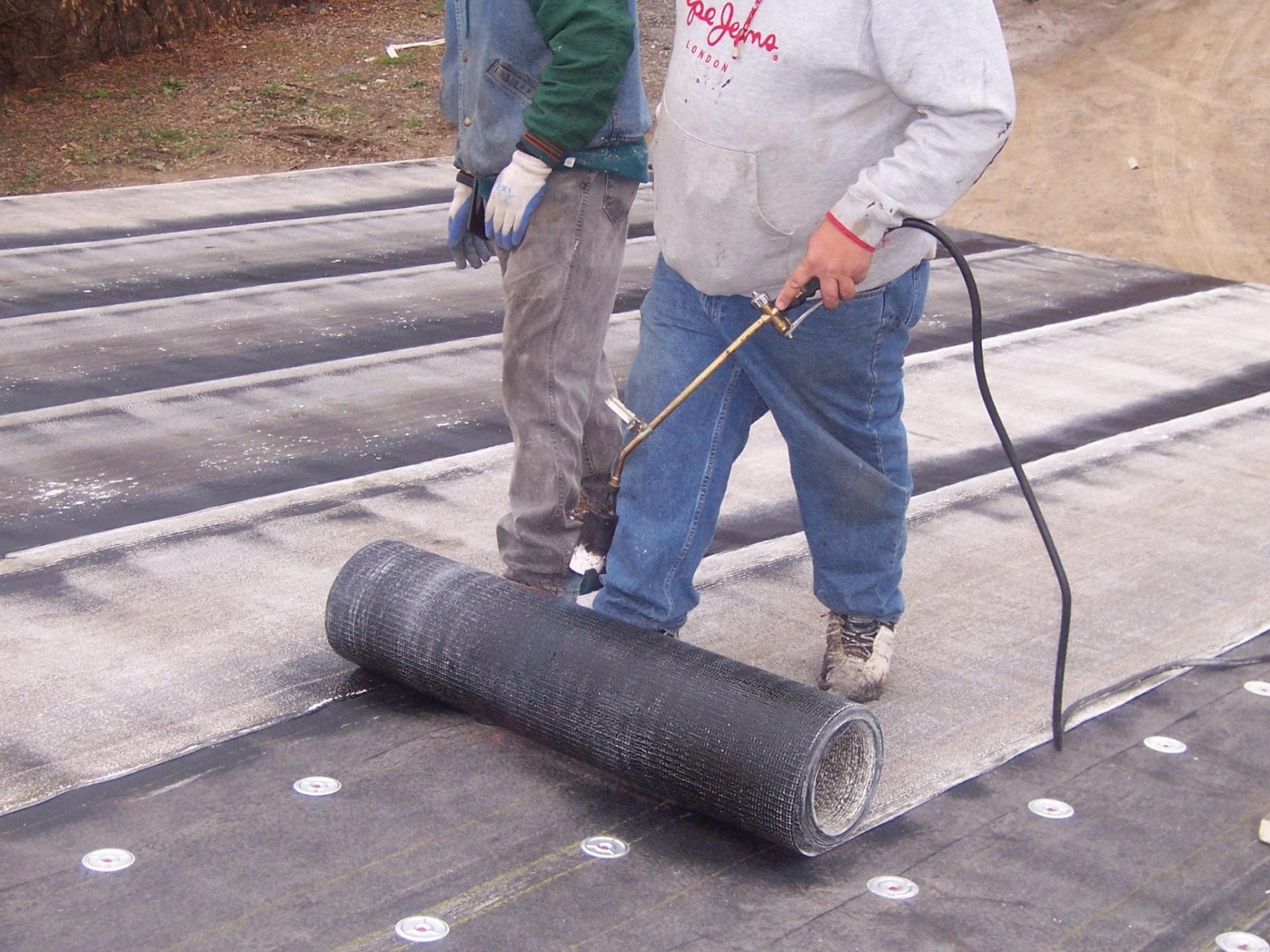 A Bobson crew applying the Polybond flat-roofing membrane on a Metro Detroit home