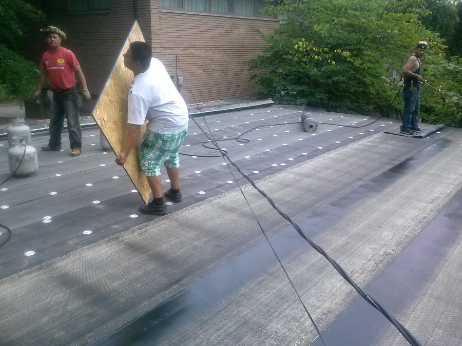 Bobson flat-roofing crew applying Polybond membrane in Detroit